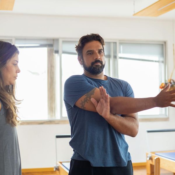 Person smiling and stretching, feeling refreshed after a workout session.